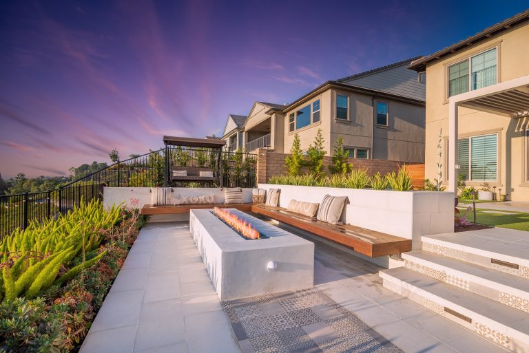 A lowered patio w/ built-in seating and contemporary fire pit. Great place for hanging out, relaxing, and entertaining. A floating hardwood bench provides ample seating for larger gatherings.