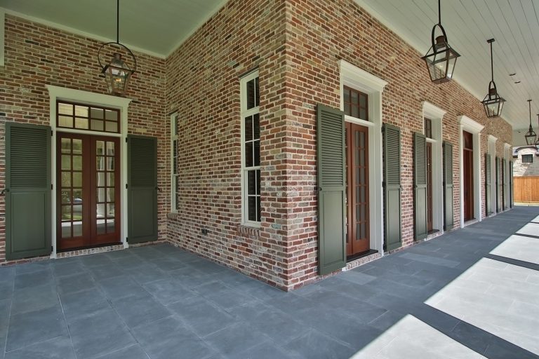 15' tall planked ceilings with ceiling mounted gas fixtures. French doors with transoms and operable shutters.