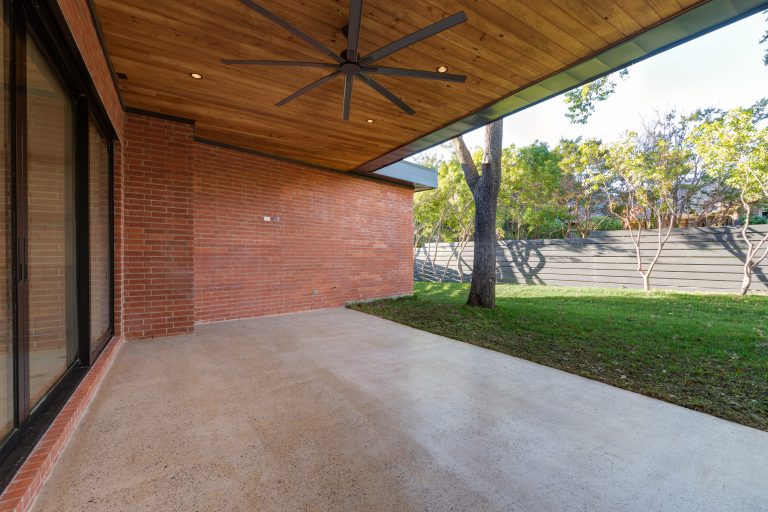 1950s backyard concrete patio kitchen photo in Dallas with a roof extension