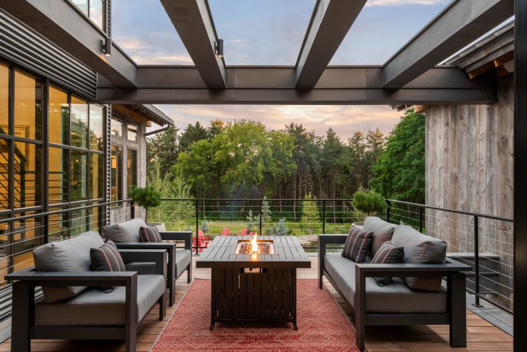 Built into the hillside, this industrial ranch sprawls across the site, taking advantage of views of the landscape. A metal structure ties together multiple ranch buildings with a modern, sleek interior that serves as a gallery for the owners collected works of art. A welcoming, airy bridge is located at the main entrance, and spans a unique water feature flowing beneath into a private trout pond below, where the owner can fly fish directly from the man-cave!