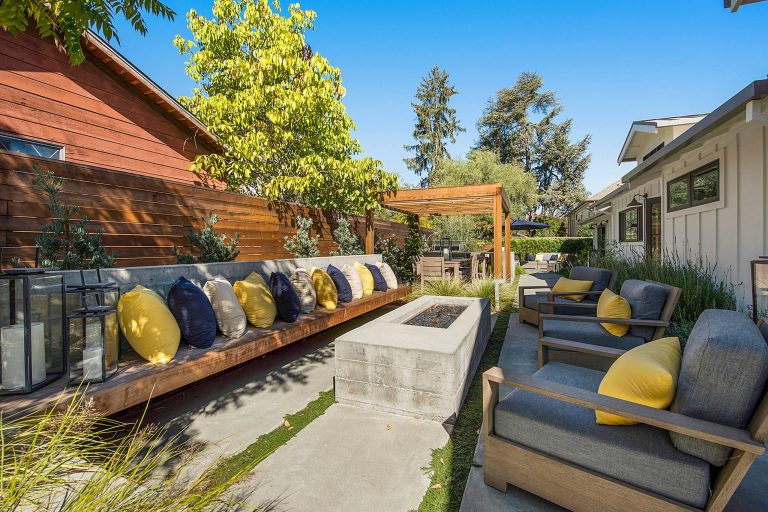 Example of a trendy concrete patio design in San Francisco with a fire pit and a pergola