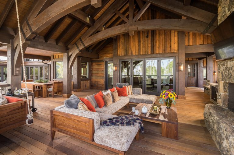 Inspiration for a large rustic backyard deck remodel in Salt Lake City with a fire pit and a roof extension