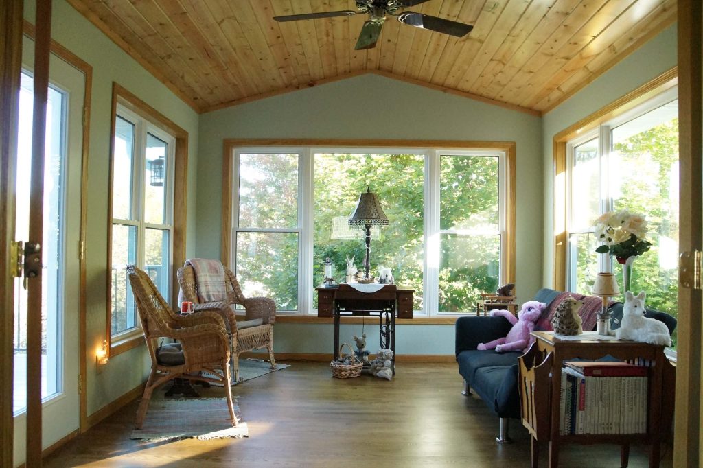 4 season porch we completed for the Bergmann family in Savage, MN. Photo Property of Lindus Construction This is an example of a mid-sized rustic porch design in Minneapolis with a roof extension. by Lindus Construction/Midwest LeafGuard | Outdoor Photos | Porch | Landscaping | Landscape Design | Outdoor Living Space | Porch Design Ideas | Outdoor Living Space Ideas | Backyard Design