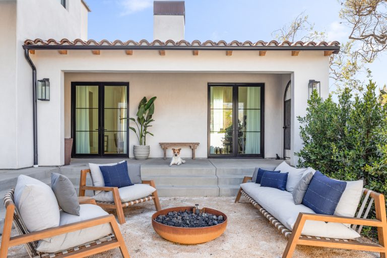 Inspiration for a large mediterranean courtyard gravel patio remodel in Los Angeles with a fire pit and no cover