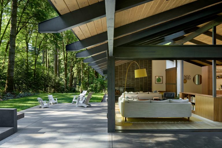 Inspiration for a large mid-century modern side yard concrete patio remodel in Portland with a fire pit and a roof extension