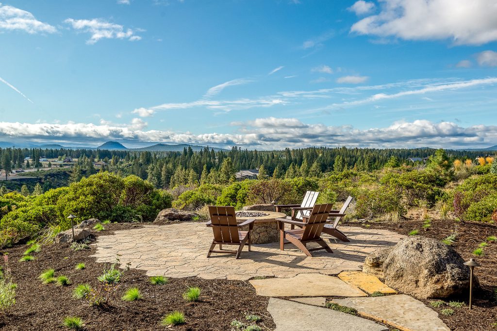 Adding on to this modern mountain home was complex and rewarding. The nature-loving Bend homeowners wanted to create an outdoor space to better enjoy their spectacular river view. They also wanted to Provide direct access to a covered outdoor space, create a sense of connection between the interior and exterior, add gear storage for outdoor activities, and provide additional bedroom and office space. The Neil Kelly team led by Paul Haigh created a covered deck extending off the living room, re-worked exterior walls, added large 8’ tall French doors for easy access and natural light, extended garage with 3rd bay, and added a bedroom addition above the garage that fits seamlessly into the existing structure.