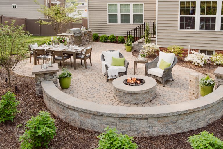 Inspiration for a mid-sized timeless backyard concrete paver patio remodel in Richmond with a fire pit and no cover