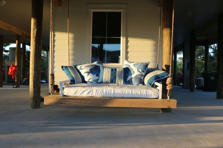 A coastal home is not complete without our original Saltaire hanging daybed swing, the newest fashion for your outdoor furnishings. Phillip Vlahos Homes, LLC by Saltaire Restoration | Outdoor Photos | Porch | Landscaping | Landscape Design | Outdoor Living Space | Porch Design Ideas | Outdoor Living Space Ideas | Backyard Design