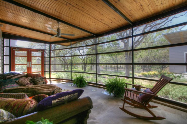 A curving screened in porch provides view to the back.
