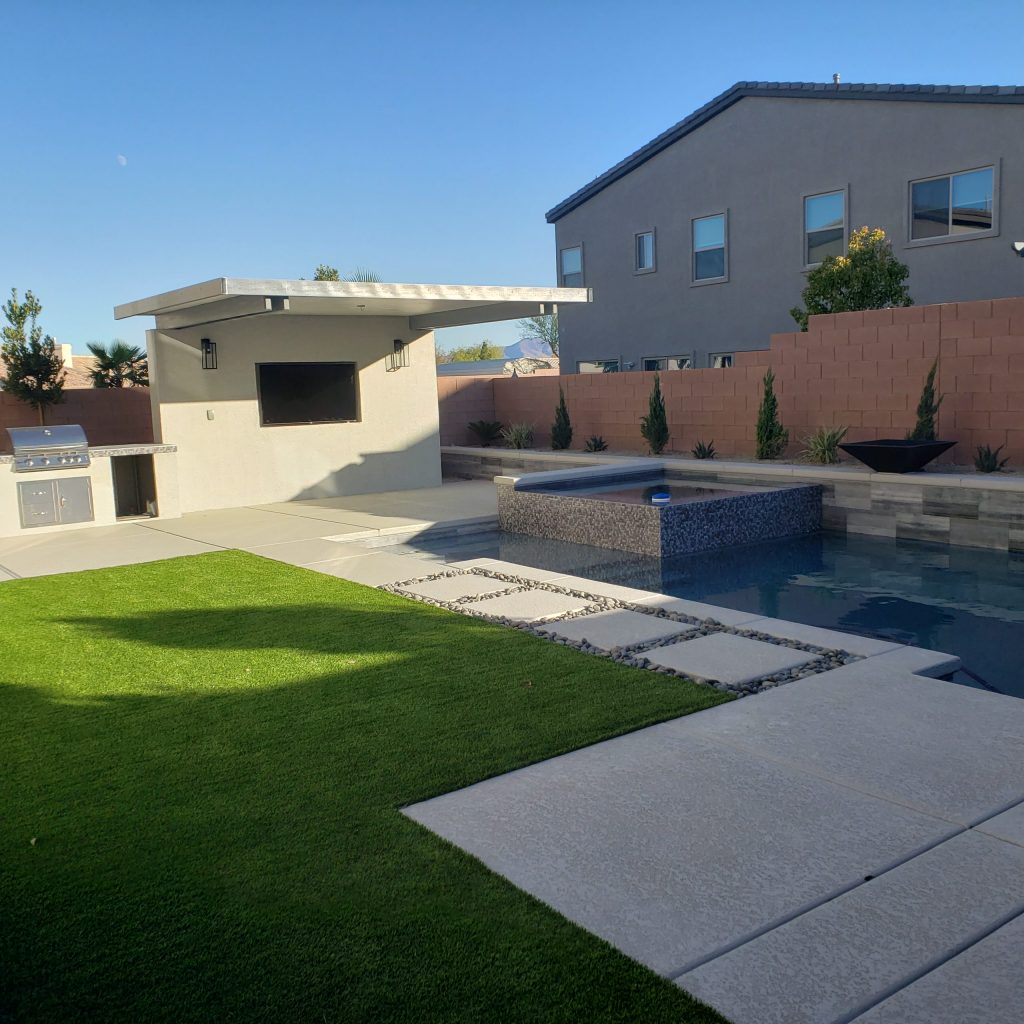 A custom media wall with attached BBQ island adds a new outdoor entertainment space to the pool area.