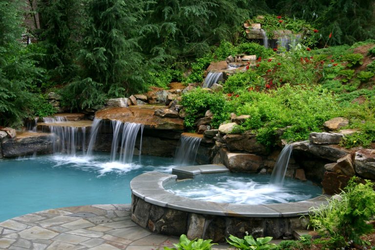 A free form, lagoon style pool with natural stone waterfalls, and spa designed by Joe A. Gayle & Associates.