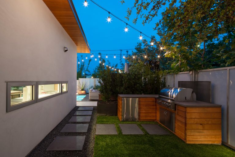 A grill area is sequestered to the side of the pool.