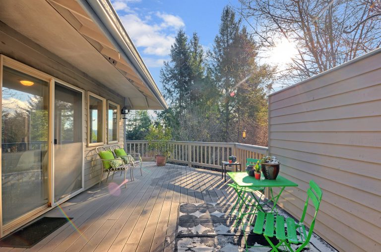 A large upper-porch off the great room with ample seating and sliding glass door.