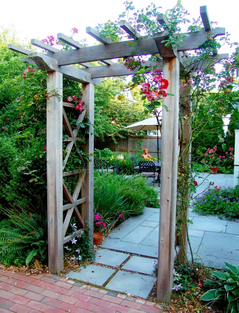 A lovely cedar arbor allows the climbing roses to frame the garden entrance.