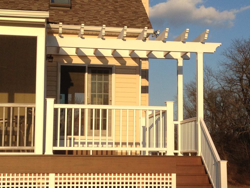 A low maintenance screen porch with a small deck and pergola.