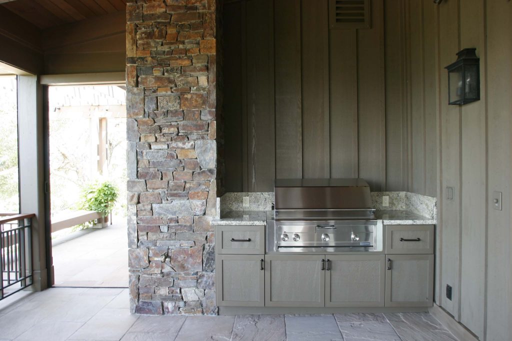 A nice outdoor barbecue tucked into the porch