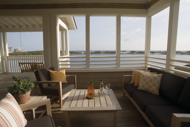 A porch furnished with comfortable seating overlooks the Gulf of Mexico at a home in the Watersound community along Scenic Highway 30A in South Walton County, Florida. [photo by Michael Granberry] by Tracery Interiors | Outdoor Photos | Porch | Landscaping | Landscape Design | Outdoor Living Space | Porch Design Ideas | Outdoor Living Space Ideas | Backyard Design