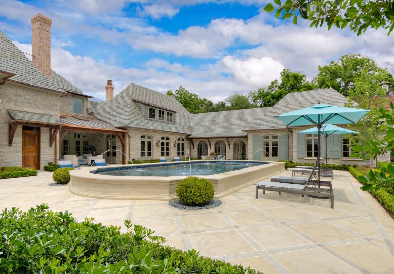 A recently completed country French estate in Dallas, Texas. This home features expansive gardens, stone walls, antique limestone paving, a raised pool, a putting green, fire pit and lush gardens with relaxing shade and blooming shrubs