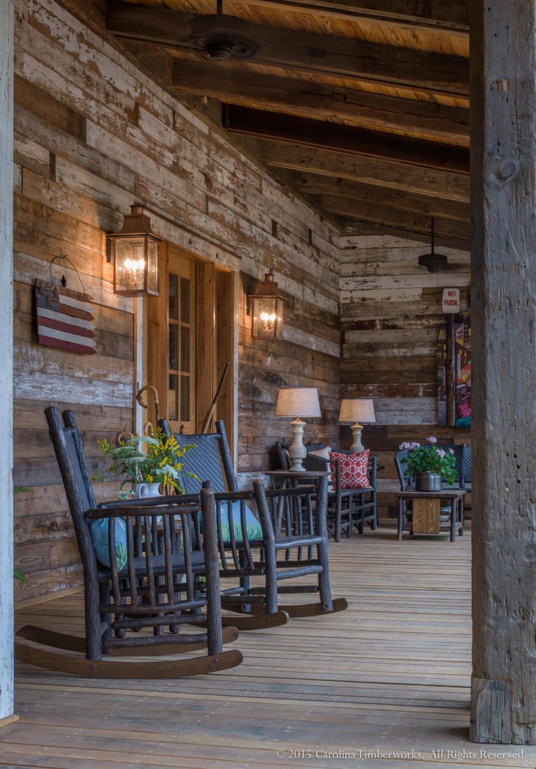 A reclaimed wood wall is one of the best front porch ideas we've seen. Reclaimed wood post and beams complete this inviting porch on the New River. © Carolina Timberworks by Carolina Timberworks | Outdoor Photos | Porch | Landscaping | Landscape Design | Outdoor Living Space | Porch Design Ideas | Outdoor Living Space Ideas | Backyard Design