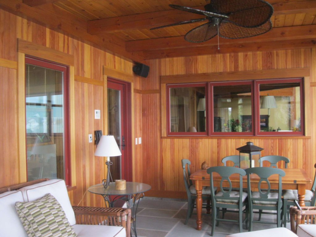 A screen porch offers room for socializing and relaxation. The windows color is Marvin 'Wine Berry.'