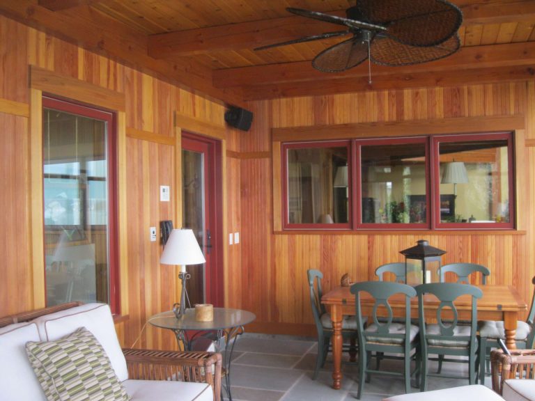 A screen porch offers room for socializing and relaxation. The windows color is Marvin 'Wine Berry.'