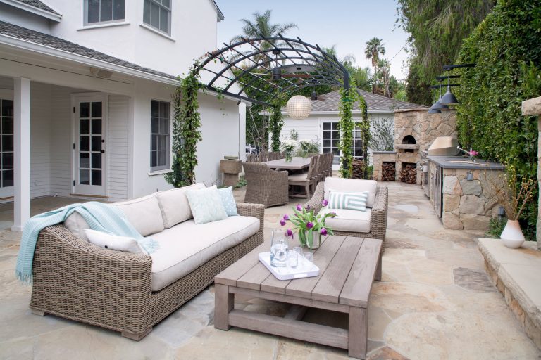 A small backyard was transformed into several outdoor rooms for cooking, dining, lounging, and playing bocce. The arbor is powder-coated steel. Lee Manning Photography by JWT Associates | Outdoor Kitchens | Backyard Design | Outdoor Living Spaces | Landscape Design