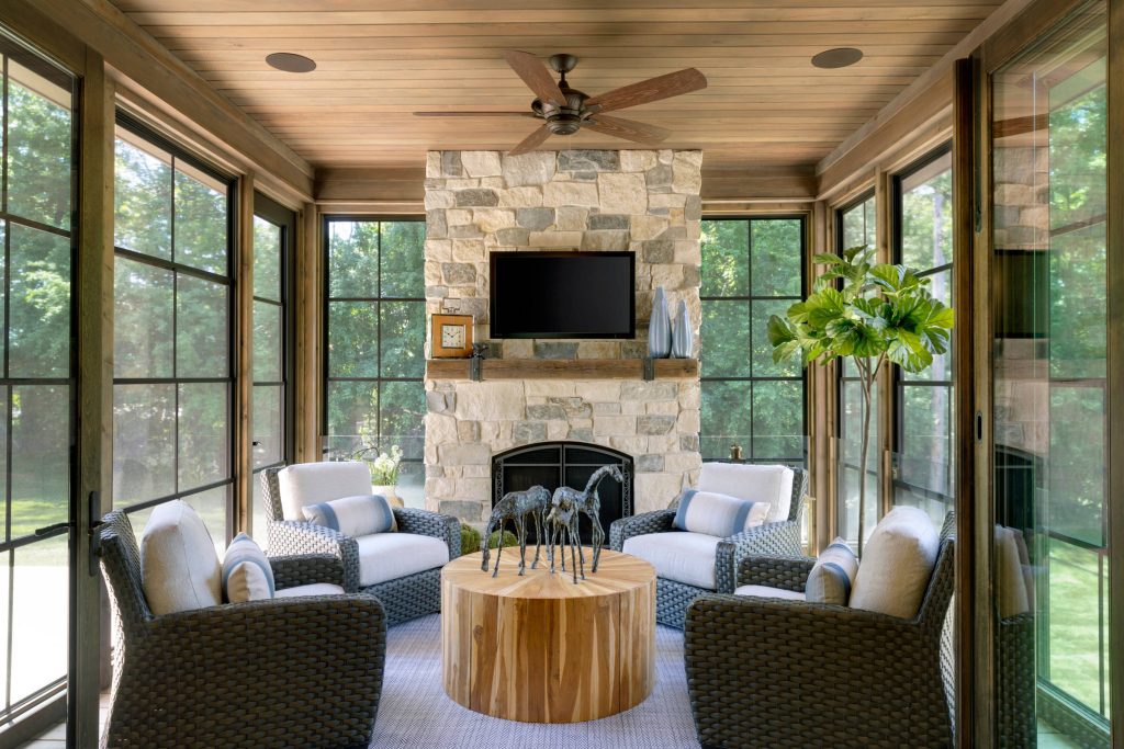 A spacious porch with fireplace is adjacent to the kitchen and dining - Photo by SpaceCrafting
