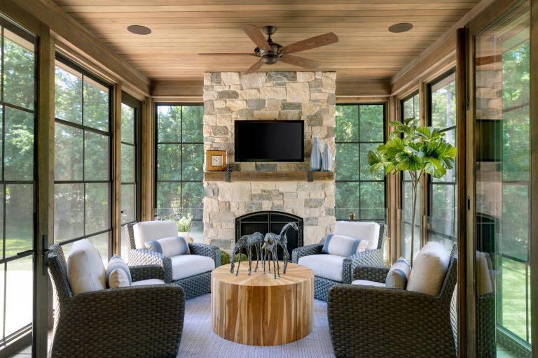 A spacious porch with fireplace is adjacent to the kitchen and dining - Photo by SpaceCrafting