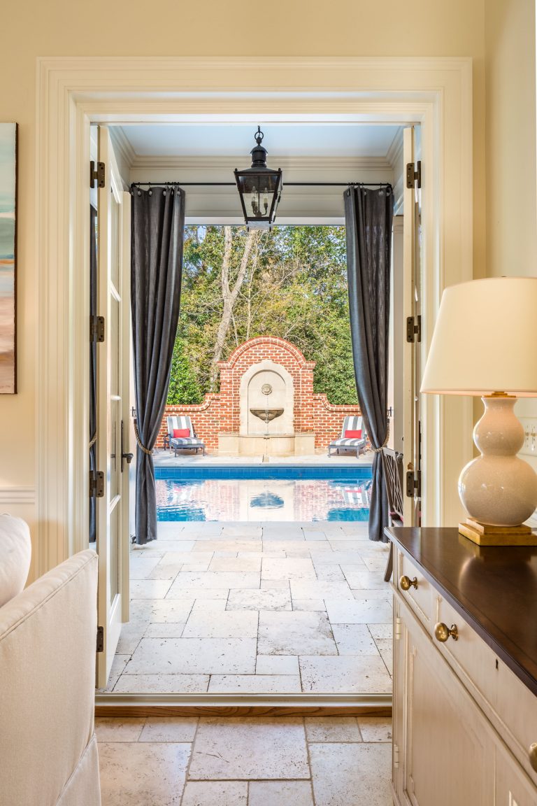 A travertine deck surrounds the pool and flows into the pool house. Photos: Suttenfield Photography