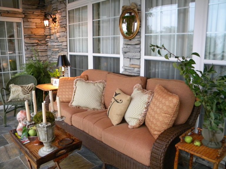 A welcome addition! We added this screened porch and decorated it to blend well with the adjoining living room. Inspiration for an eclectic porch remodel in Charlotte by Christie Thomas | Outdoor Photos | Porch | Landscaping | Landscape Design | Outdoor Living Space | Porch Design Ideas | Outdoor Living Space Ideas | Backyard Design