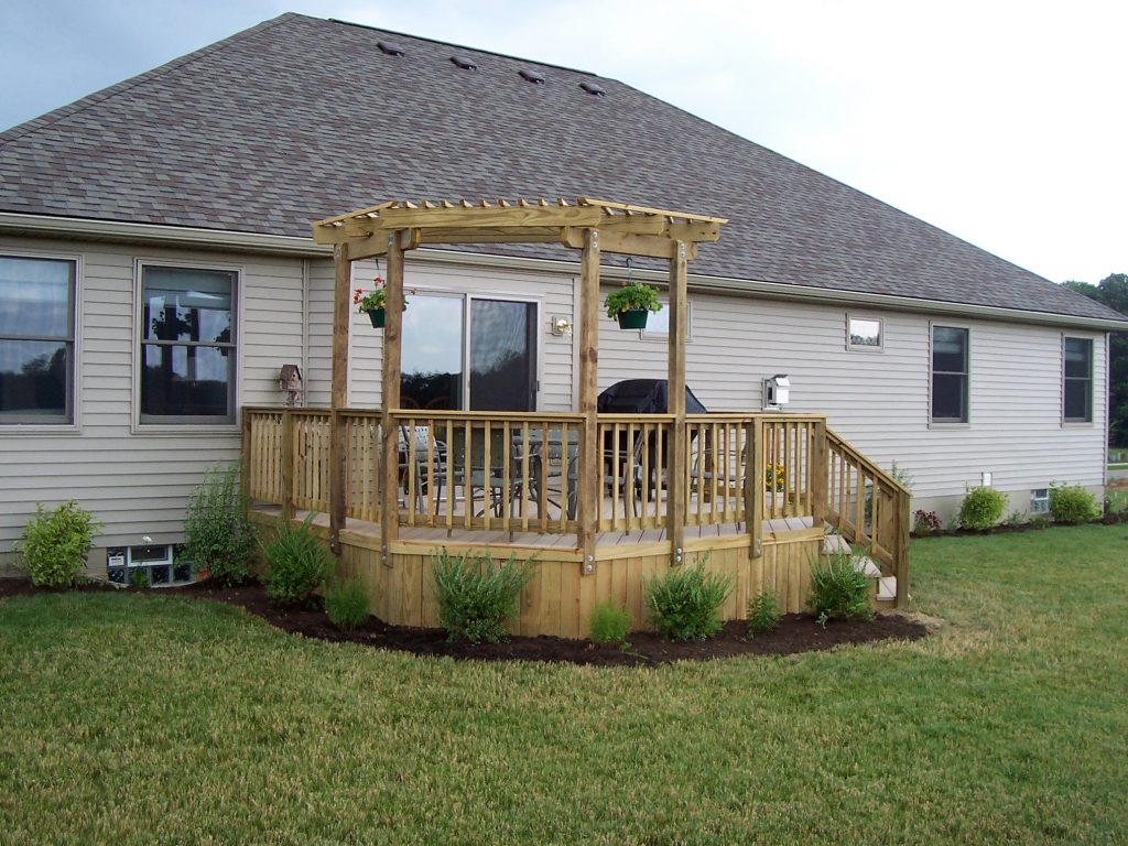 A wood deck with a perogla (trellis).