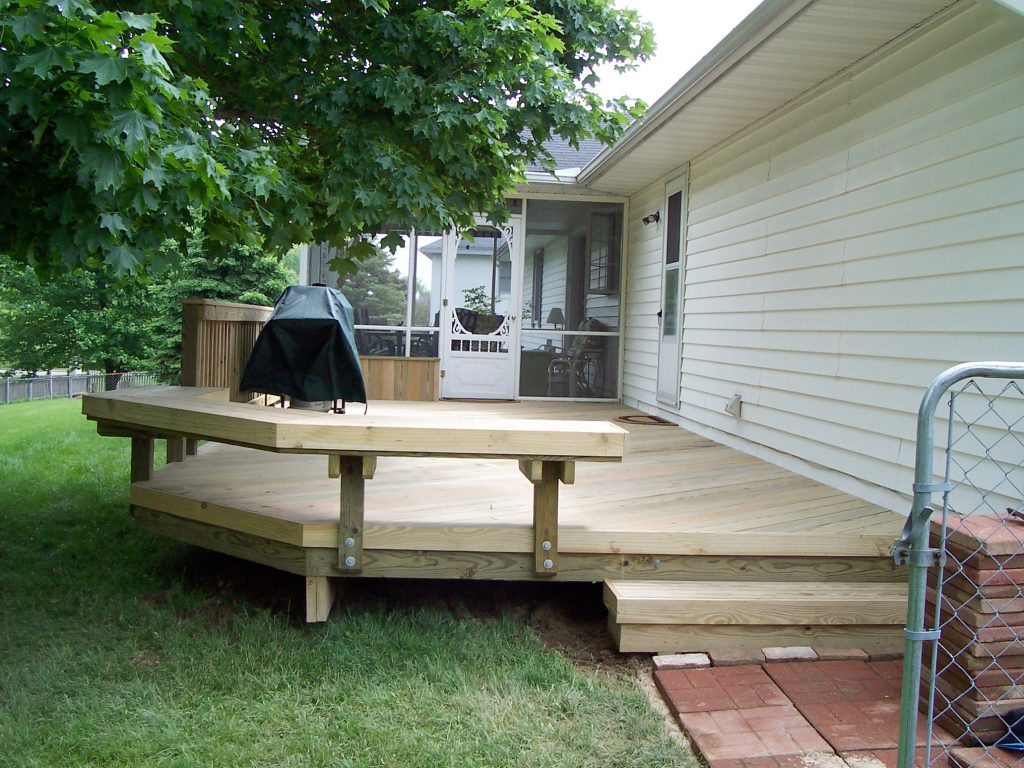 A wood deck with a wood bench