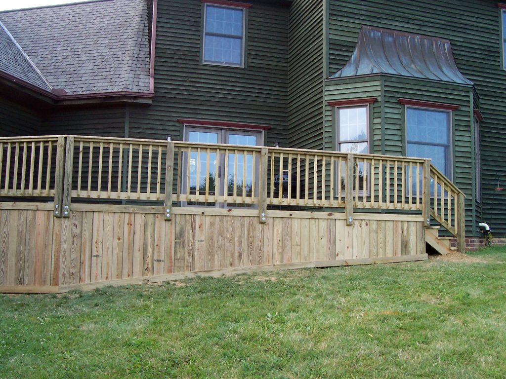A wood deck with solid board skirting.