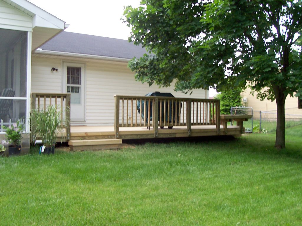 A wood deck with wood rails.