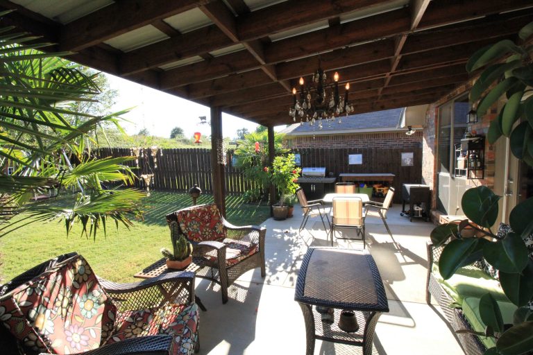 Addition of large concrete slab as well as covered area with metal roof.