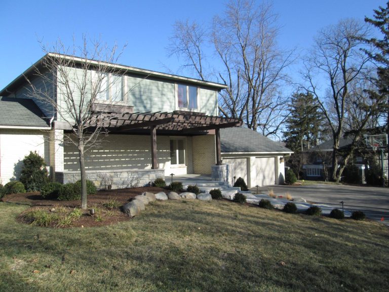 After - Buff to Blue walls with bluestone floor, ceder pergola , landscape and outdoor lighting. This is an example of a traditional stone front porch design in Other with a pergola. by Liapis Landscape & Design | Outdoor Photos | Porch | Landscaping | Landscape Design | Outdoor Living Space | Porch Design Ideas | Outdoor Living Space Ideas | Backyard Design