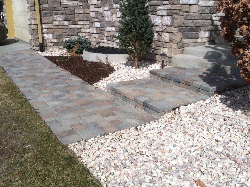 After' photo showing new paver walkway and steps. An easy and relatively inexpensive way to spruce up the entrance and add curb appeal.