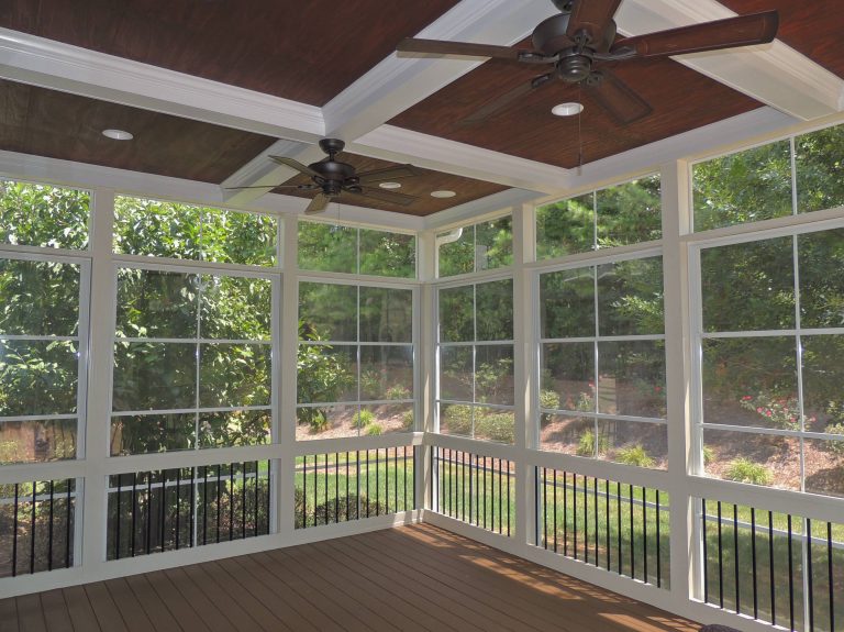 An EzeBreeze porch with a coffer ceiling, Trex decking and Deckorator railing.
