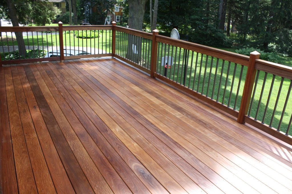 An Ipe deck with mahogany posts. Metal Bronze traditional balusters. Copper post caps.