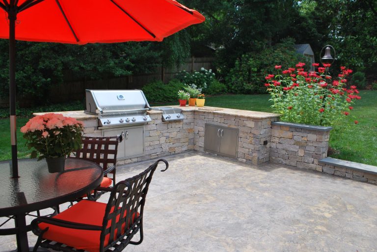 An outdoor kitchen with stained concrete, and Fieldstone counters with stainless steel cabinet and grill is perfect for entertaining. --Photo credit: Candace M.P. Smith Architect by Candace M P Smith Architect | Outdoor Kitchens | Backyard Design | Outdoor Living Spaces | Landscape Design