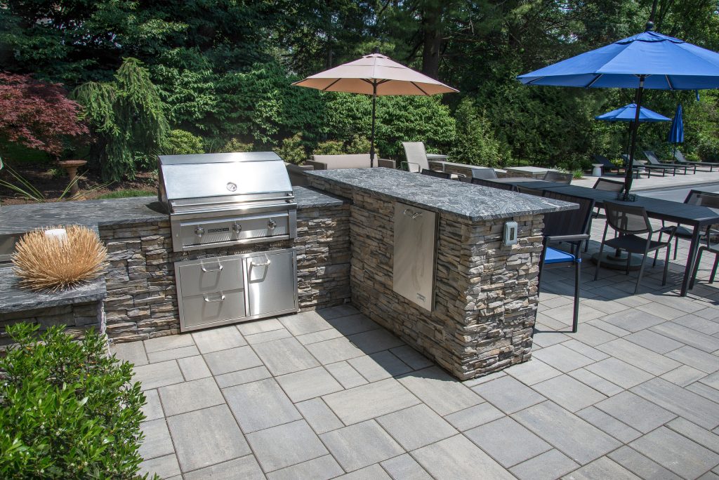 An outdoor patio with grilling, dining & entertaining spaces.