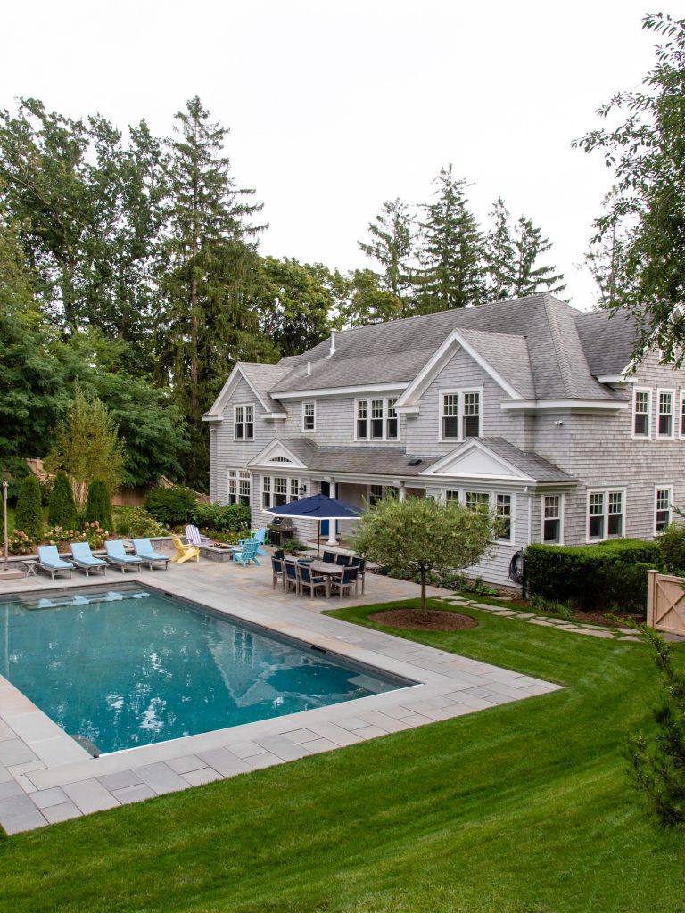 An unremarkable back yard was turned into a resort-style pool and spa for a large family.