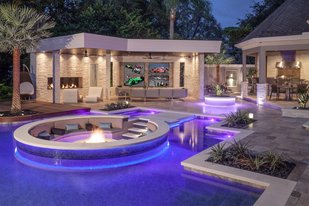Appearing to float within the pool, the 8 foot circular lowered fire lounge and patio area provides a prime vantage point for embracing the total outdoor experience.

Photography by Joe Traina by Ryan Hughes Design/Build | Pool design | Pool Contracting | Swimming Pool Ideas | Swimming Pool Design Ideas