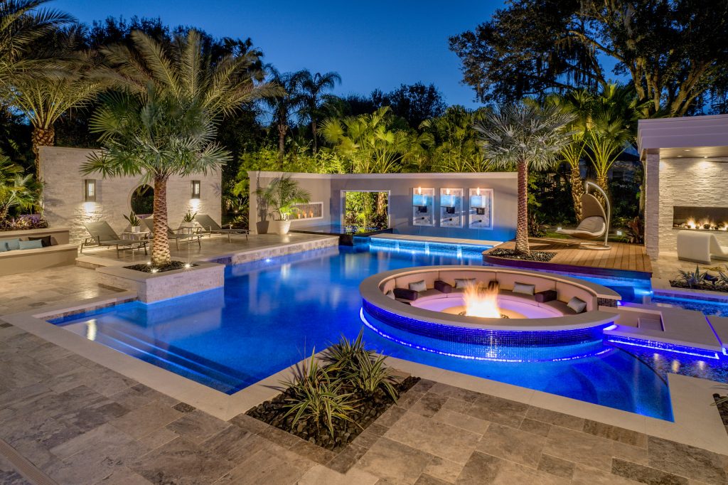 Appearing to float within the pool, the 8 foot circular lowered fire lounge and patio area provides a prime vantage point for embracing the total outdoor experience. Photography by Joe Traina