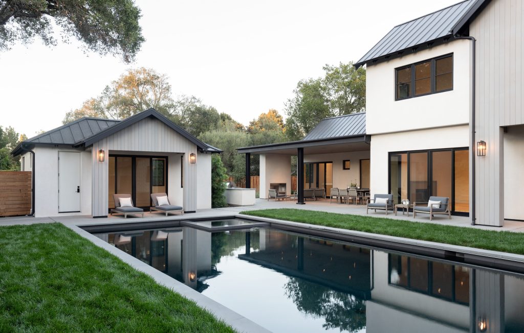 Architect : CKA Light grey stained cedar siding, stucco, and standing seam metal roof. Pool house, dark bottom pool