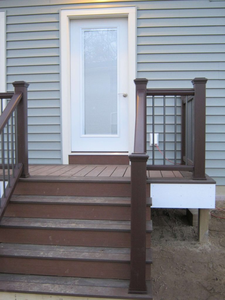 Azek pvc composite decking with Trex Transcend railing and contermporary spindles.