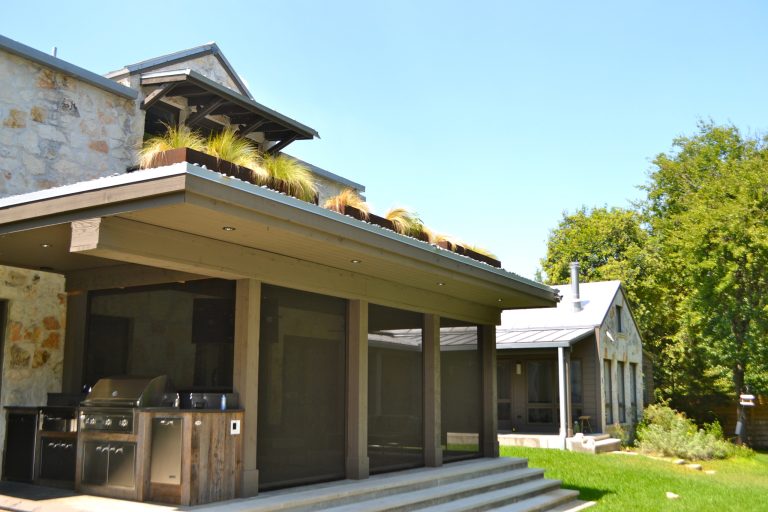 Back of house - screened in porch, side angle with out door grill.
