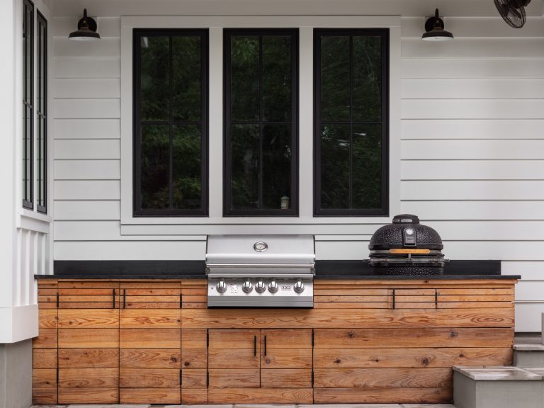 Back patio grilling area of modern luxury farmhouse in Pass Christian Mississippi photographed for Watters Architecture by Birmingham Alabama based architectural and interiors photographer Tommy Daspit.
