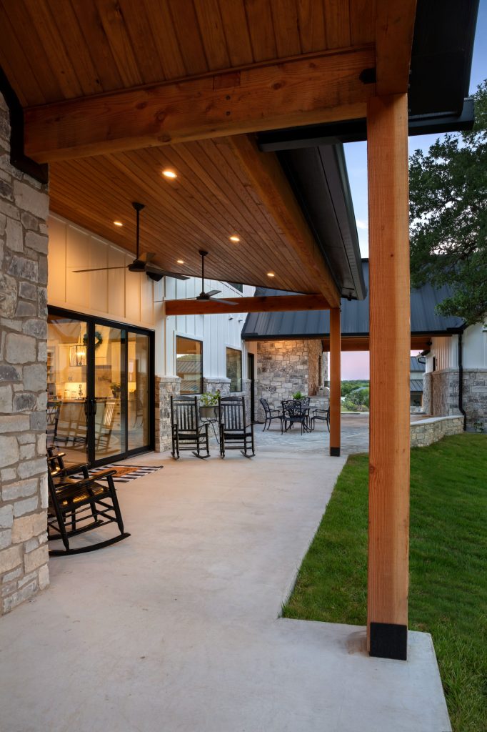 Back porch featuring an exposed timber truss, covered seating area and dogtrot to casita.