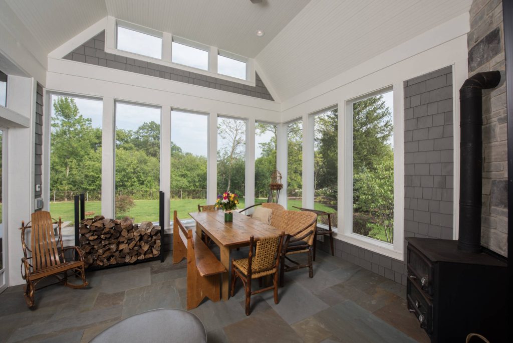Back sunroom with vintage stove and furniture
